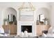 Cozy living room featuring a fireplace, a decorative chandelier, and white cabinets at 125 Maison Court, Roswell, GA 30076