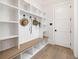 Organized mudroom with custom built-ins, bench seating, and wood flooring at 125 Maison Court, Roswell, GA 30076