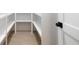 Walk-in pantry features bright white shelving and laminate flooring at 125 Maison Court, Roswell, GA 30076