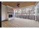 Covered patio with a fireplace, wood floors, and views of the surrounding trees at 125 Maison Court, Roswell, GA 30076