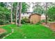 Large backyard with lush greenery, mature trees, and well-maintained lawn at 1338 Talcott Pl, Decatur, GA 30033