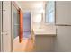 Bathroom featuring a tub with glass door, bright vanity, and window with natural light at 1338 Talcott Pl, Decatur, GA 30033