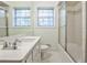 Clean bathroom with white fixtures, tiled shower, and large vanity mirror at 1338 Talcott Pl, Decatur, GA 30033