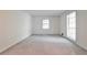 Bright, airy bedroom with neutral carpet, white walls, and natural light from two windows at 1338 Talcott Pl, Decatur, GA 30033