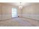 Spacious bedroom with patterned wallpaper, chandelier, and a large window providing natural light at 1338 Talcott Pl, Decatur, GA 30033