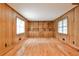Versatile room with wood paneled walls, built-in shelving, hardwood floors, and natural light at 1338 Talcott Pl, Decatur, GA 30033