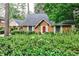 Charming home featuring brick facade, covered porch, and mature landscaping at 1338 Talcott Pl, Decatur, GA 30033