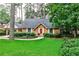 Charming single-story home with a brick facade, lush landscaping, and a well-manicured green lawn at 1338 Talcott Pl, Decatur, GA 30033