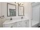 Modern bathroom with double sinks, marble countertop, and separate tub area at 2079 Wellborn Rd, Lithonia, GA 30058