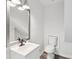 This bathroom features a sleek sink and a modern faucet, plus a contemporary mirror with stylish lighting at 2079 Wellborn Rd, Lithonia, GA 30058