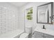 Updated bathroom featuring subway tile shower and vanity with gray cabinetry at 2079 Wellborn Rd, Lithonia, GA 30058
