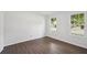 Bright bedroom featuring wood floors, neutral walls, and two windows at 2079 Wellborn Rd, Lithonia, GA 30058
