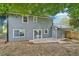 Exterior back view of the home showcasing a gray siding, patio, and backyard at 2079 Wellborn Rd, Lithonia, GA 30058