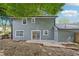 Exterior back view of the home showcasing a gray siding, patio, and backyard at 2079 Wellborn Rd, Lithonia, GA 30058