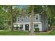 Charming home featuring a manicured lawn, gray siding, white brick and a striking black front door at 2079 Wellborn Rd, Lithonia, GA 30058