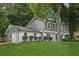 Charming two-story home featuring a manicured lawn, gray siding and a convenient attached garage at 2079 Wellborn Rd, Lithonia, GA 30058