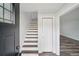 Inviting foyer features stylish wood and white stairs, fresh paint and durable flooring at 2079 Wellborn Rd, Lithonia, GA 30058