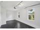 Naturally lit two car garage that offers a clean space for vehicles and extra storage; it has windows overlooking the yard at 2079 Wellborn Rd, Lithonia, GA 30058