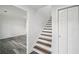 Bright hallway features wood-look flooring, crisp white trim, and a staircase leading to the upper level of the home at 2079 Wellborn Rd, Lithonia, GA 30058