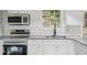 Modern kitchen featuring stainless steel appliances, granite countertops, and subway tile backsplash at 2079 Wellborn Rd, Lithonia, GA 30058