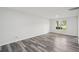 An expansive living room with gray, wood-look flooring and a bright window allows natural light to fill the space at 2079 Wellborn Rd, Lithonia, GA 30058
