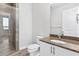 Contemporary bathroom with glass shower, granite countertop, and a white commode and cabinet at 270 17Th Nw St # 4306, Atlanta, GA 30363
