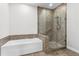 Bathroom featuring a bathtub and glass shower, along with tile flooring and backsplash at 270 17Th Nw St # 4306, Atlanta, GA 30363