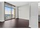 Bedroom with hardwood floors, large window views, and access to the closet at 270 17Th Nw St # 4306, Atlanta, GA 30363