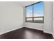 Bedroom with hardwood floors and a large window with city views, bringing in natural light at 270 17Th Nw St # 4306, Atlanta, GA 30363
