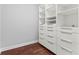 Custom closet with built-in shelving, drawers, and ample storage space on beautiful hardwood floors at 270 17Th Nw St # 4306, Atlanta, GA 30363