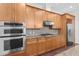 Spacious kitchen featuring stainless steel appliances, double ovens and wooden cabinetry at 270 17Th Nw St # 4306, Atlanta, GA 30363