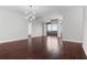 Open living area with hardwood floors and a modern light fixture near the large balcony windows at 270 17Th Nw St # 4306, Atlanta, GA 30363
