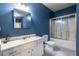Bathroom with a classic vanity, framed mirror, toilet, and tub/shower combination at 3300 Pierce St, College Park, GA 30337