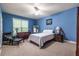 Carpeted bedroom with blue walls, large window, and ceiling fan at 3300 Pierce St, College Park, GA 30337
