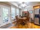 Bright dining area features wood table and chairs, hardwood floors, and lots of natural light at 3300 Pierce St, College Park, GA 30337