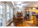 Bright dining area features wood table and chairs, hardwood floors, and lots of natural light at 3300 Pierce St, College Park, GA 30337