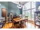 Charming dining room with a large window, chandelier, and hardwood floors at 3300 Pierce St, College Park, GA 30337