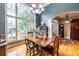 Bright dining room with a large window, chandelier, and hardwood floors at 3300 Pierce St, College Park, GA 30337