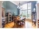 Elegant dining room featuring a large window, chandelier, and hardwood floors at 3300 Pierce St, College Park, GA 30337