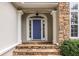 Inviting front entrance with a blue door, stone accents, and elegant columns at 3300 Pierce St, College Park, GA 30337