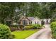 Charming home featuring a beautifully landscaped front yard with stone accents and a well-maintained lawn at 3300 Pierce St, College Park, GA 30337