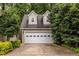 Attached two-car garage with dormers, providing ample parking and storage space at 3300 Pierce St, College Park, GA 30337