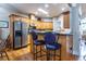 Traditional kitchen with stainless steel refrigerator, wood cabinets, granite countertops, and hardwood floors at 3300 Pierce St, College Park, GA 30337