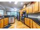 Well-equipped kitchen with stainless steel appliances, granite countertops, and wooden cabinets at 3300 Pierce St, College Park, GA 30337