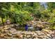Picturesque koi pond with waterfall and rock features creating a serene backyard setting at 3300 Pierce St, College Park, GA 30337