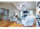 Cozy living room with a stone fireplace, vaulted ceiling, and gleaming hardwood floors at 3300 Pierce St, College Park, GA 30337