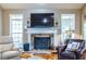 Beautiful stone fireplace with white mantel and large windows filling the living room with light at 3300 Pierce St, College Park, GA 30337
