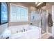 Bright bathroom with soaking tub and glass-enclosed shower at 3300 Pierce St, College Park, GA 30337