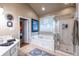 Bright bathroom with white vanity, tiled floors, soaking tub, and glass-enclosed shower at 3300 Pierce St, College Park, GA 30337