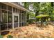 Charming patio with stone flooring, screened porch, table, chairs, and a verdant surrounding landscape at 3300 Pierce St, College Park, GA 30337